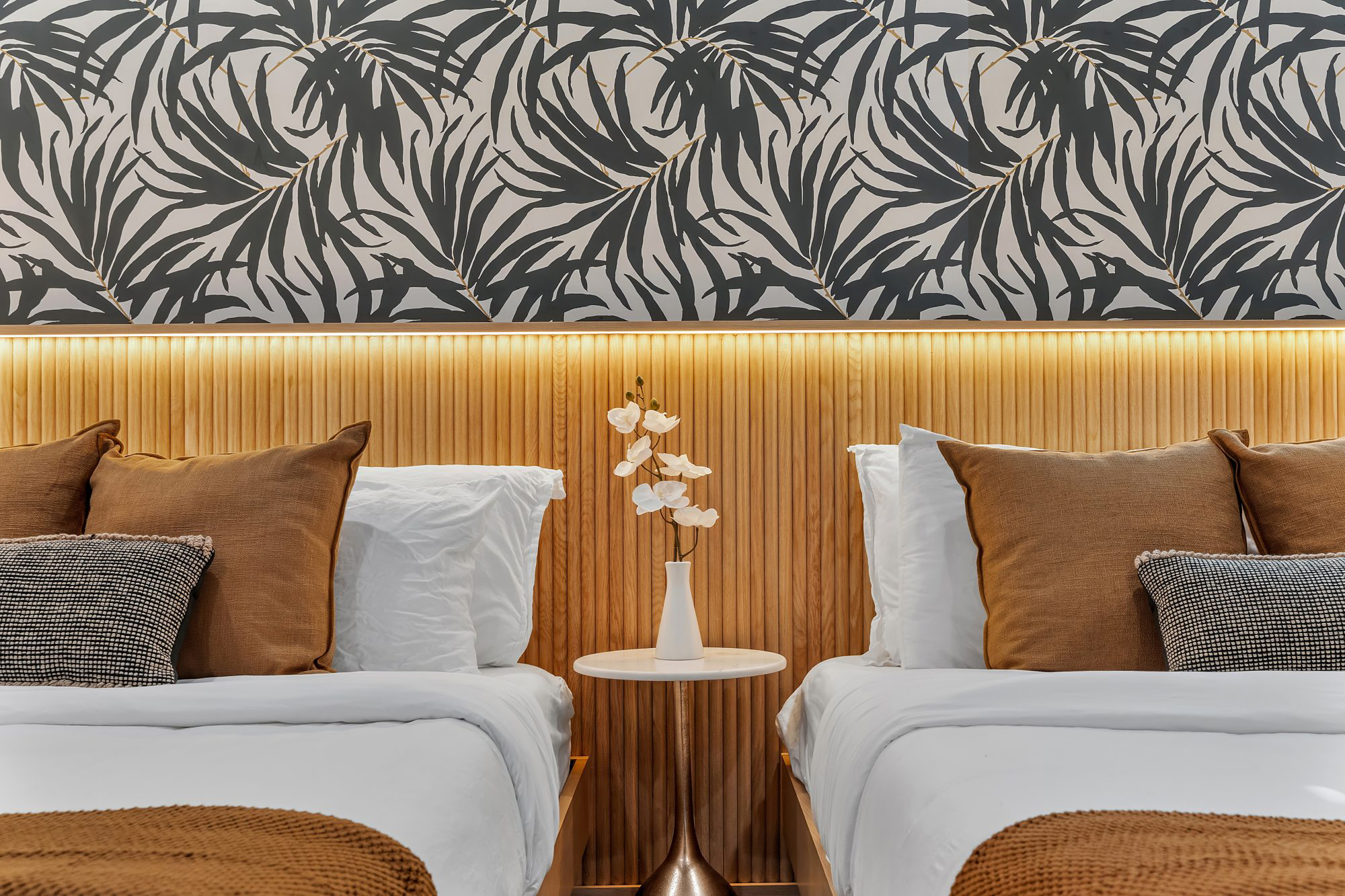 Guest bedroom with twin beds in a Miami vacation rental designed by Naomi Satya Interiors